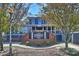 Bulldog Taproom/Social boasts a brick sign and a blue exterior, framed by trees on a sunny day at 908 Academy St, Charlotte, NC 28205