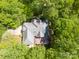 Aerial view of a well-maintained home surrounded by lush trees at 9101 Oak Bluff Ct, Marvin, NC 28173