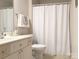 Comfortable bathroom featuring single vanity, large mirror and a tub with shower at 9101 Oak Bluff Ct, Marvin, NC 28173