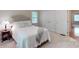 Carpeted bedroom featuring ample storage, neutral walls, and a queen-sized bed at 9101 Oak Bluff Ct, Marvin, NC 28173