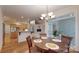 Open-concept dining room connects kitchen and living area, featuring hardwood floors at 9101 Oak Bluff Ct, Marvin, NC 28173