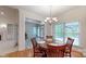 Bright dining room with hardwood floors and natural light overlooking sunroom at 9101 Oak Bluff Ct, Marvin, NC 28173