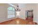 Formal dining room featuring hardwood floors, window and chandelier at 9101 Oak Bluff Ct, Marvin, NC 28173