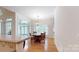 Traditional dining room with chandelier, hardwood floors, and bright windows at 9101 Oak Bluff Ct, Marvin, NC 28173