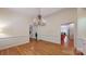 Dining room features hardwood floors, chandelier, and decorative wainscoting at 9101 Oak Bluff Ct, Marvin, NC 28173