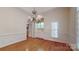 Formal dining room with hardwood floors, wainscoting, and modern chandelier at 9101 Oak Bluff Ct, Marvin, NC 28173