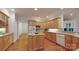 Well-lit kitchen with wooden cabinets, countertops, kitchen island, and hardwood floors at 9101 Oak Bluff Ct, Marvin, NC 28173