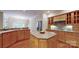 Spacious kitchen features wooden cabinets, kitchen island, and hardwood flooring at 9101 Oak Bluff Ct, Marvin, NC 28173
