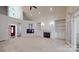 Spacious living room with fireplace, built-in shelving, and large windows for natural light, creating a cozy gathering space at 9101 Oak Bluff Ct, Marvin, NC 28173