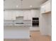 Bright kitchen features white cabinetry, stainless appliances, and a center island at Tbd Boomer Ct # 1, Statesville, NC 28677