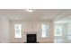 Bright living room with fireplace, large windows and neutral decor at Tbd Boomer Ct # 1, Statesville, NC 28677