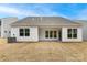 A home's backyard with vinyl siding, large windows, and a covered patio, perfect for relaxing or entertaining at Tbd Boomer Ct # 2, Statesville, NC 28677