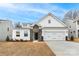 Charming white two-story home featuring a two-car garage and a beautifully landscaped front yard at Tbd Boomer Ct # 2, Statesville, NC 28677