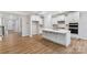 Spacious kitchen with stainless steel appliances, an island with bar seating, and hardwood flooring at Tbd Boomer Ct # 2, Statesville, NC 28677