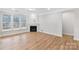Bright living room featuring a fireplace, large windows, and hardwood floors at Tbd Boomer Ct # 2, Statesville, NC 28677