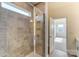 Bathroom with shower featuring glass door and ceramic tile surround, leading to bedroom at Tbd Boomer Ct # 3, Statesville, NC 28677