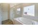 Bathroom featuring large tub, shower with glass door, and ceramic tile surround at Tbd Boomer Ct # 3, Statesville, NC 28677