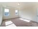 Bedroom with neutral walls, carpeted floors, and natural light from two windows at Tbd Boomer Ct # 3, Statesville, NC 28677