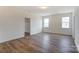 Spacious bedroom with wood floors, neutral walls, and ample natural light from two large windows at Tbd Boomer Ct # 3, Statesville, NC 28677