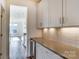 Long view of a butler pantry that includes white cabinets and gray countertops at Tbd Boomer Ct # 3, Statesville, NC 28677