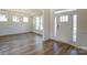 Bright living room with wood floors, crown molding, wainscotting, and a large window at Tbd Boomer Ct # 3, Statesville, NC 28677