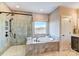 Modern bathroom featuring a luxurious soaking tub, tiled shower with glass door, and elegant fixtures at Tbd Boomer Ct # 5, Statesville, NC 28677