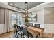 Elegant dining room with modern chandelier, hardwood floors and lots of natural light at Tbd Boomer Ct # 5, Statesville, NC 28677