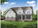 Charming two-story home with stone accents, gray siding and landscaped front yard at Tbd Boomer Ct # 5, Statesville, NC 28677