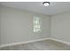 Bright bedroom featuring gray walls, trim, and gray wood-look flooring at 103 Moore Ave, Mount Holly, NC 28120