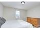A bright bedroom features grey walls, light-colored floors, a window, and a dresser at 103 Moore Ave, Mount Holly, NC 28120