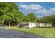 Attractive home featuring a welcoming front porch and well-maintained lawn, shaded by lush trees at 103 Moore Ave, Mount Holly, NC 28120