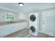 Clean and functional laundry room features stainless steel appliances and light-colored decor at 103 Moore Ave, Mount Holly, NC 28120