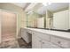 Bathroom featuring a double sink vanity with white cabinets, large mirror, and walk-in closet at 11544 Costigan Ln # 8306, Charlotte, NC 28277