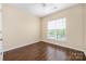 Bright bedroom features hardwood floors and a window offering natural light at 11544 Costigan Ln # 8306, Charlotte, NC 28277