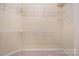 Walk-in closet with white wire shelving and neutral walls at 11544 Costigan Ln # 8306, Charlotte, NC 28277