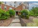 Building entrance featuring well-maintained landscaping, a pathway, and signage at 11544 Costigan Ln # 8306, Charlotte, NC 28277