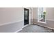 Hallway with gray carpet, a door, wainscoting, trim and a window at 11544 Costigan Ln # 8306, Charlotte, NC 28277