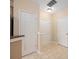 Neutral-toned hallway with a tiled floor, multiple doors, and base molding at 11544 Costigan Ln # 8306, Charlotte, NC 28277