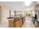 Open-concept kitchen with granite countertop island and stainless appliances overlooking a living area at 11544 Costigan Ln # 8306, Charlotte, NC 28277
