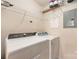 Bright laundry room features modern white washer and dryer, with ample storage shelving for convenience at 11544 Costigan Ln # 8306, Charlotte, NC 28277