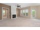 Bright living room with neutral walls, a fireplace, ceiling fan, and three large windows at 11544 Costigan Ln # 8306, Charlotte, NC 28277