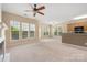 Bright living room with fireplace, ceiling fan, bar counter and large windows overlooking trees at 11544 Costigan Ln # 8306, Charlotte, NC 28277
