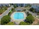 Aerial view of a community pool with crystal clear water, plenty of seating and manicured landscaping at 11544 Costigan Ln # 8306, Charlotte, NC 28277
