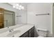 Bathroom featuring a single sink vanity, mirror and a shower/tub combo at 119 Legacy Ln, Harmony, NC 28634