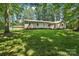 Single-story home with well-maintained lawn, a shed in the back, and lush trees at 119 Legacy Ln, Harmony, NC 28634
