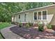 Charming home exterior with a well-manicured lawn and lush landscaping adding curb appeal at 119 Legacy Ln, Harmony, NC 28634