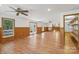 Open-concept living room with wood-look flooring, ceiling fans, windows, and natural light at 119 Legacy Ln, Harmony, NC 28634