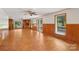 Spacious living room featuring wood-look flooring, a ceiling fan and natural light from windows at 119 Legacy Ln, Harmony, NC 28634