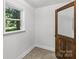 Room featuring neutral paint, an exterior window and a wooden door at 119 Legacy Ln, Harmony, NC 28634