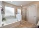 Bathroom featuring a garden tub, separate shower, and a privacy window at 1226 Clingman Dr, Fort Mill, SC 29715